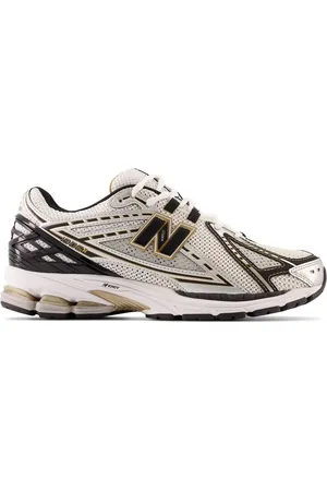 New Balance 1906 trainers in silver and gold