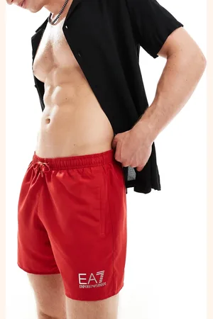 EA7 Armani gold logo swim shorts in