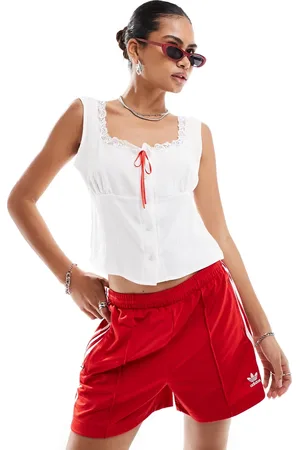 Reclaimed Milkmaid cami top with lace trim and red ribbon in