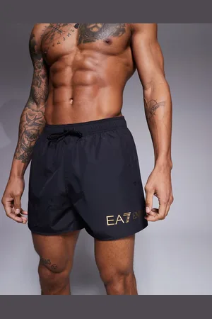 EA7 Armani gold logo swim shorts in