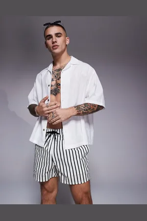 ASOS Seersucker swim shorts in short length in black and stripe